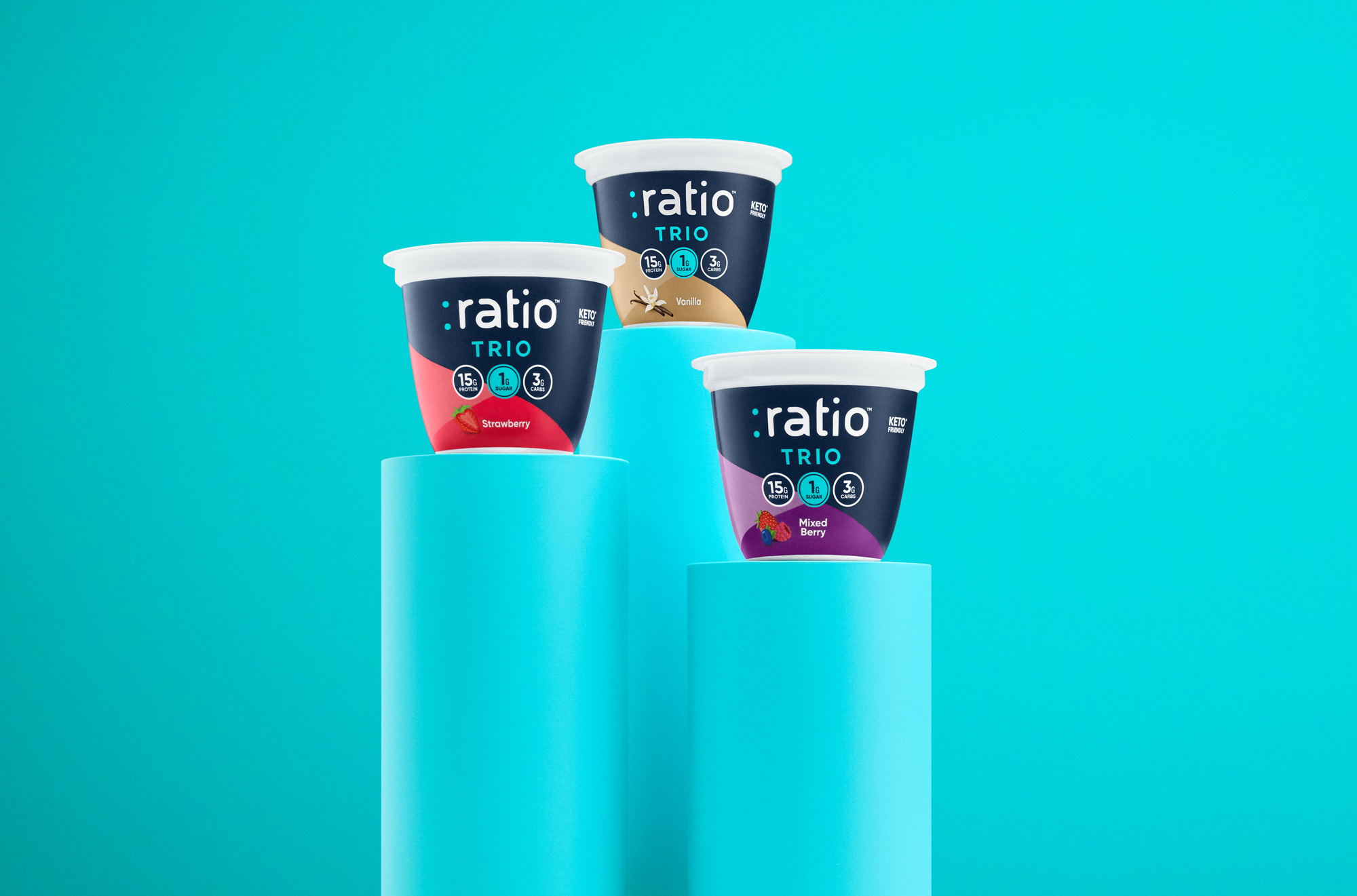 Three :ratio TRIO Dairy Snack cups in Strawberry, Mixed Berry, and Vanilla flavors.