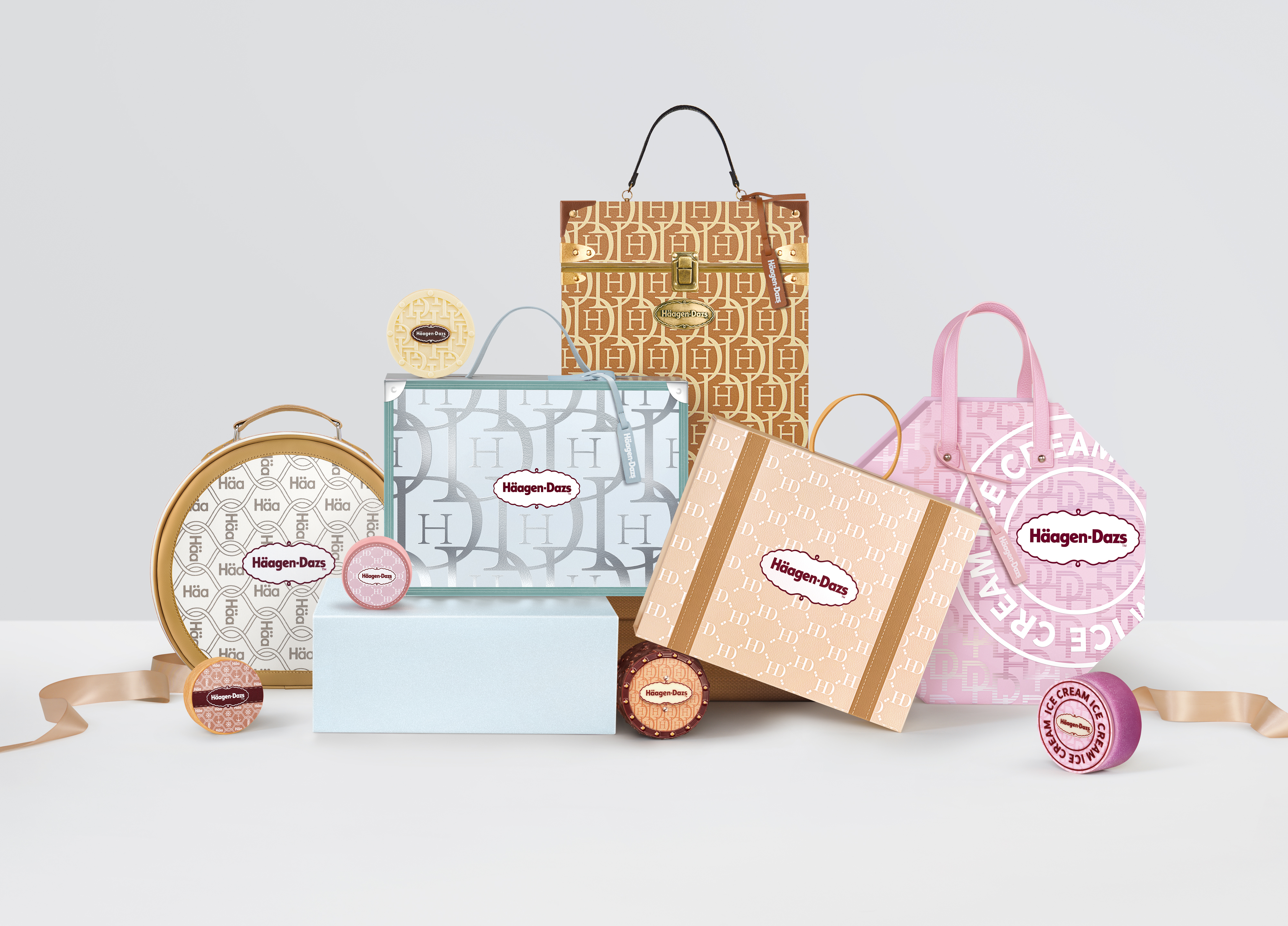 Assortment of Häagen-Dazs' monogramed Mid-Autumn Festival gift boxes with travel-themed package design in various colors, shapes and sizes.