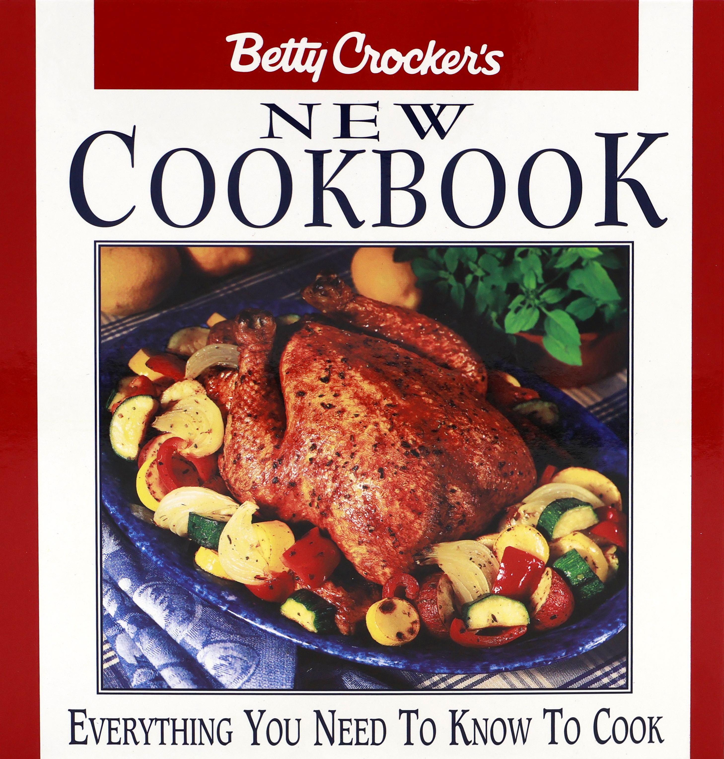 Cover of the 1996 Betty Crocker Cookbook with a red cover that has worded at bottom “Everything You Need to Know to Cook” and a large square has a whole roasted chicken surrounded by grilled vegetables.